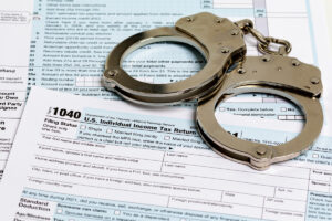 Tax forms with handcuffs on top of them in El Paso.