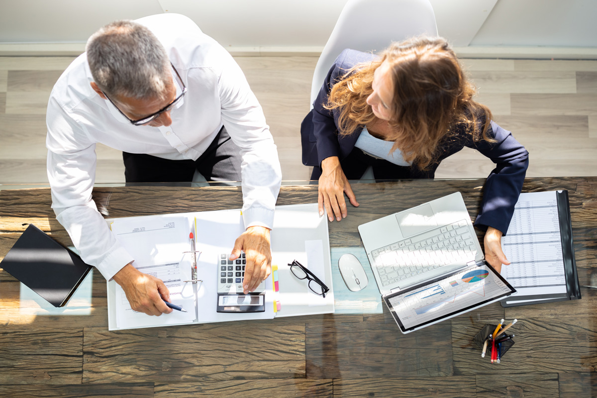 A woman and man going over accounting documents in El Paso.